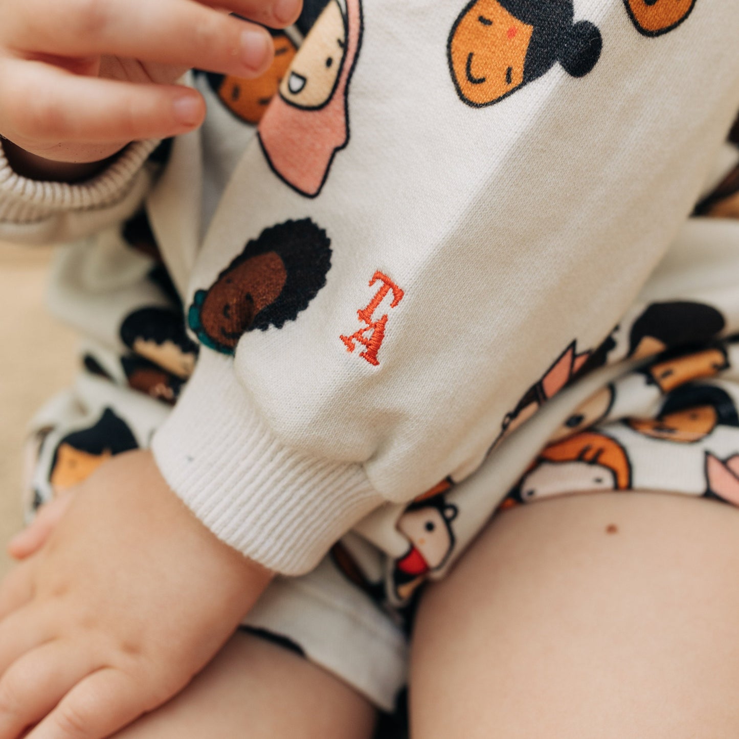 TINY ALLIES ALL OVER JUMPER