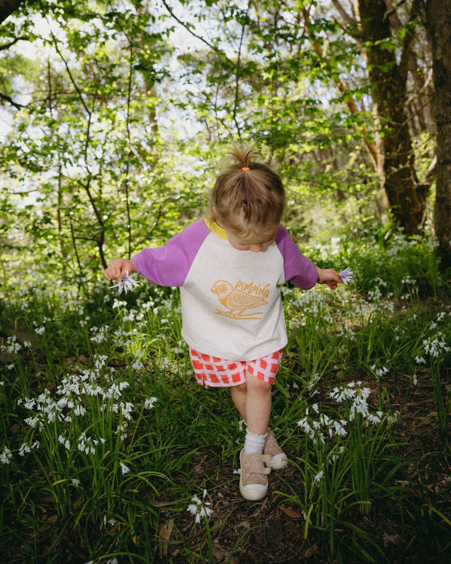 Child in a forest with flowers and trees