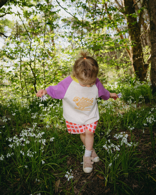 Child in a forest with flowers and trees